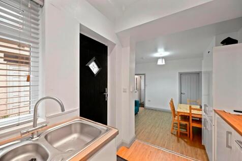 Bright and clean kitchen area with modern stain...