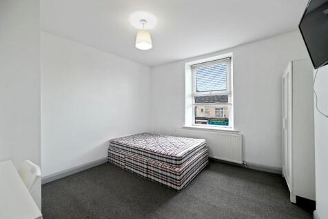 A clean and bright double bedroom featuring a l...