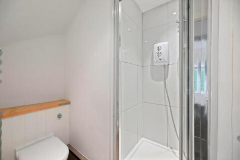 A clean and modern bathroom featuring a compact...