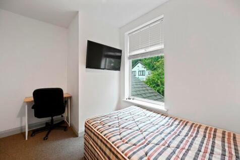 A neat and bright single bedroom featuring a co...