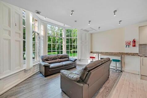 A bright and inviting living room featuring lar...