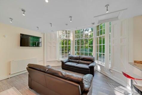Bright and inviting living room featuring large...