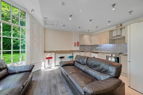 A bright and contemporary living room featuring...