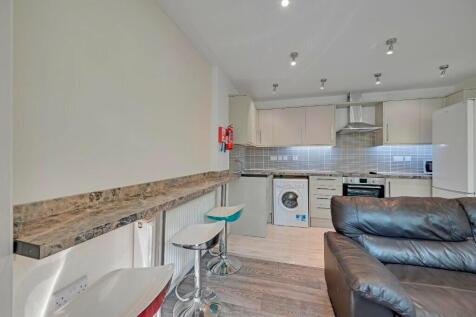 A modern kitchen with a sleek breakfast bar and...
