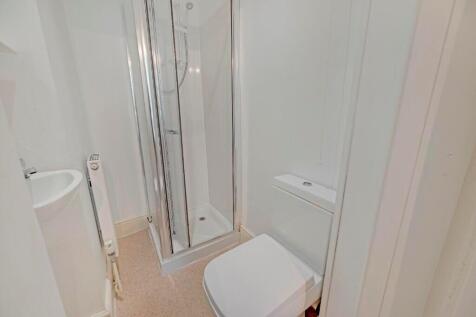 Bright and modern bathroom suite featuring a sl...