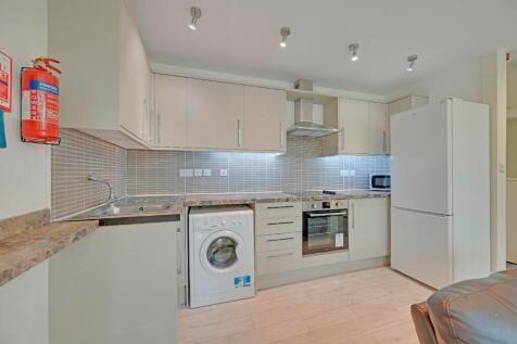 Bright and modern kitchen featuring white cabin...