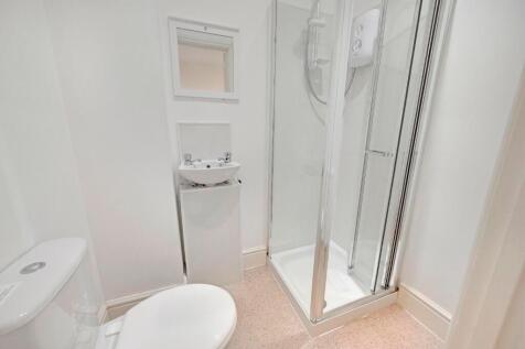 A clean and modern bathroom featuring a compact...