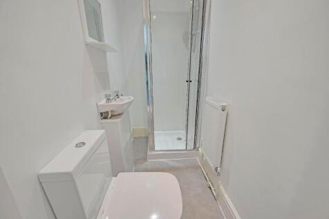 Bright and clean bathroom featuring a modern sh...