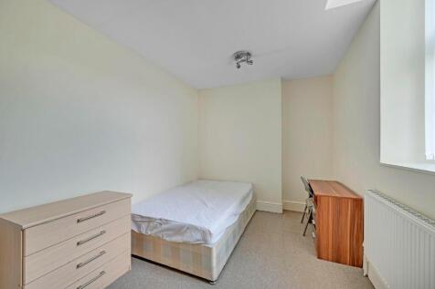 A neat and bright single bedroom featuring a co...