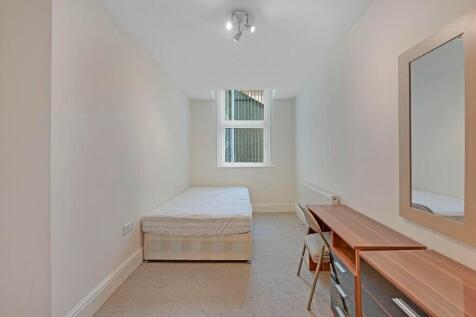 A neat and simple single bedroom featuring a be...