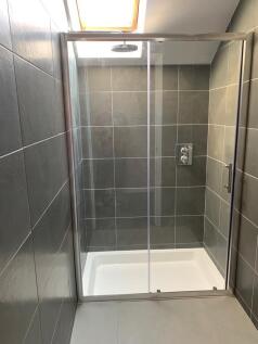 Modern bathroom suite featuring a spacious walk...