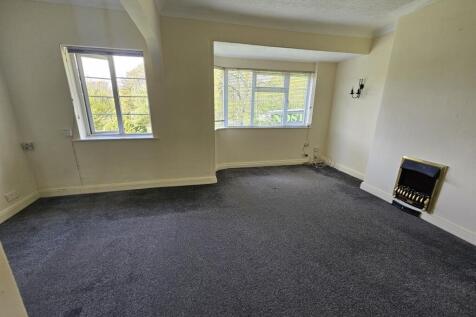 A spacious living room featuring large windows ...