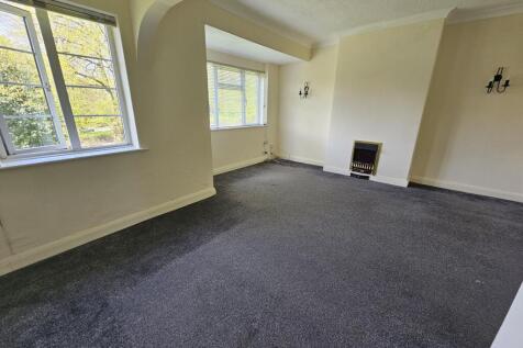 Bright living room with two large windows allow...