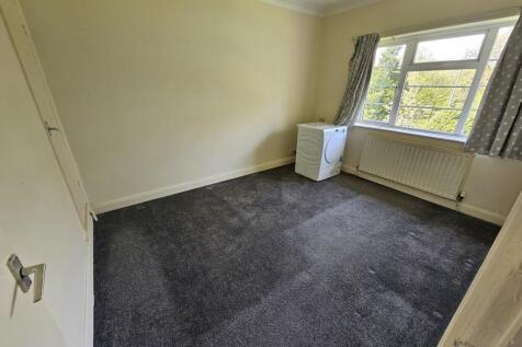 A bright and tidy double bedroom featuring a la...