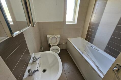 A clean and modern bathroom featuring a white b...