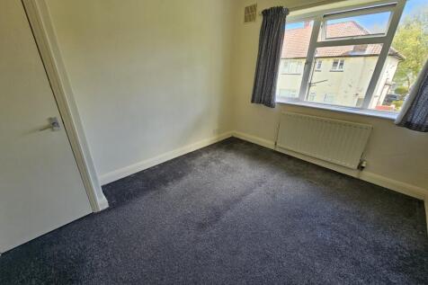 A bright and clean single bedroom featuring a l...