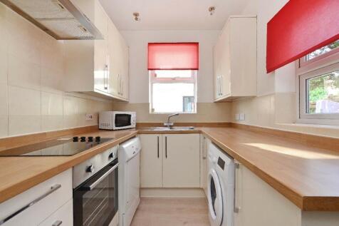 Bright and tidy kitchen featuring modern applia...