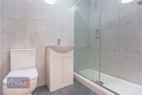 A modern bathroom suite featuring a clean, tile...