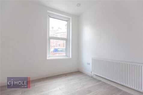 A bright and clean minimalist room with a large...
