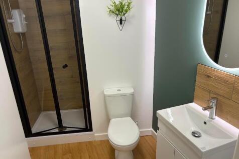 Bright and modern bathroom featuring a walk-in ...