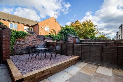 A well-maintained and inviting garden space fea...