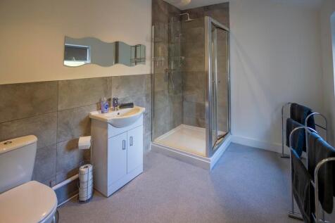 A modern and well-maintained bathroom suite fea...