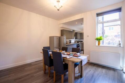 Bright and modern kitchen featuring a dining ta...