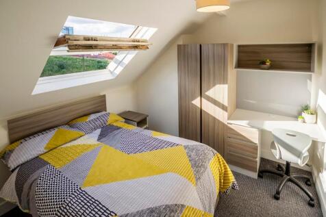 Cozy double bedroom featuring a comfortable bed...