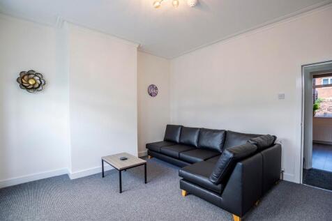 A neat and inviting living room featuring a mod...