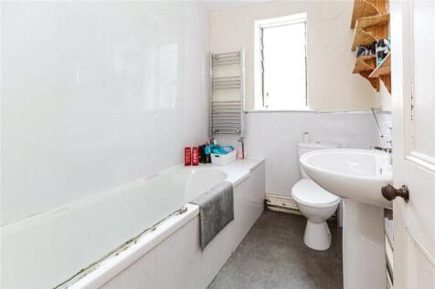 A bright, clean bathroom suite featuring a larg...