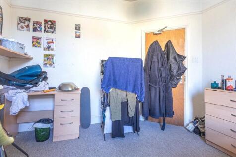 A compact and functional room featuring a simpl...