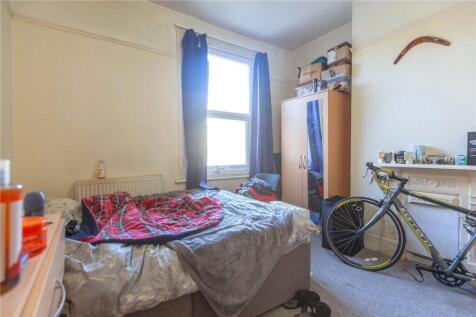 Cozy bedroom featuring a comfortable bed positi...