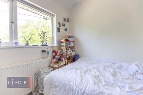 A bright and cozy double bedroom featuring a la...