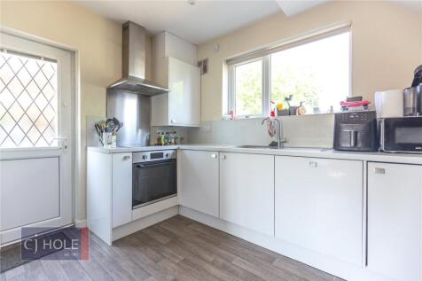 Bright and modern kitchen featuring ample white...