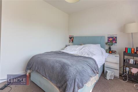 Bright and cozy double bedroom featuring a comf...