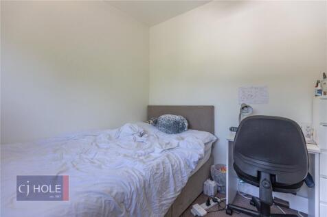Cozy single bedroom featuring a comfortable bed...