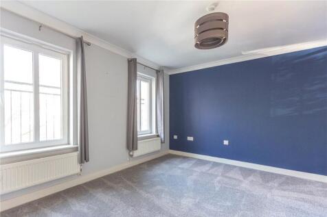 Bright and spacious master bedroom featuring la...