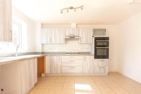 Bright and modern kitchen featuring ample cabin...