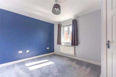 A bright and clean double bedroom featuring a l...