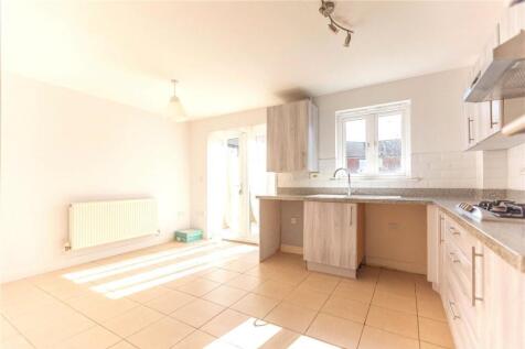 Bright and airy kitchen space featuring ample n...