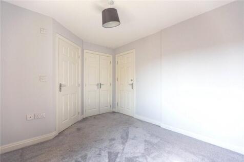 A bright and clean double bedroom with neutral ...