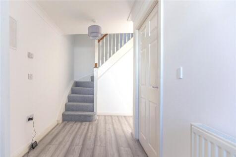 Bright and clean hallway with light wood floori...