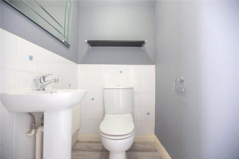 A clean and modern single toilet featuring a wh...