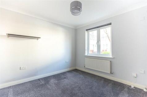 Bright and clean single bedroom featuring neutr...