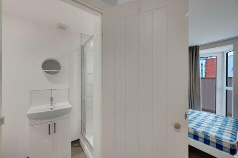 A clean and bright compact bathroom area featur...