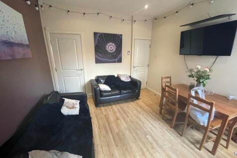 A cozy living room featuring comfortable black ...