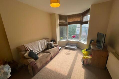 A cozy living room with a comfortable brown sof...