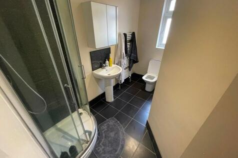 A clean and modern bathroom featuring a curved ...