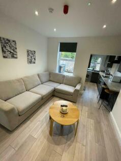 A modern living room featuring a comfortable L-...