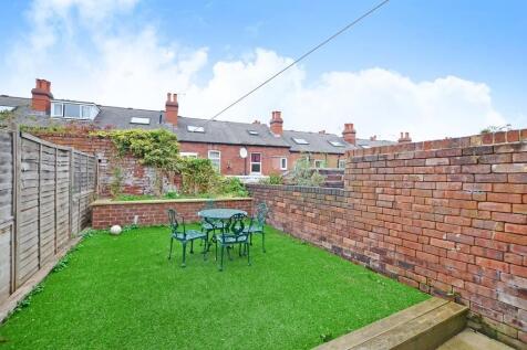 A well-maintained private garden featuring a gr...